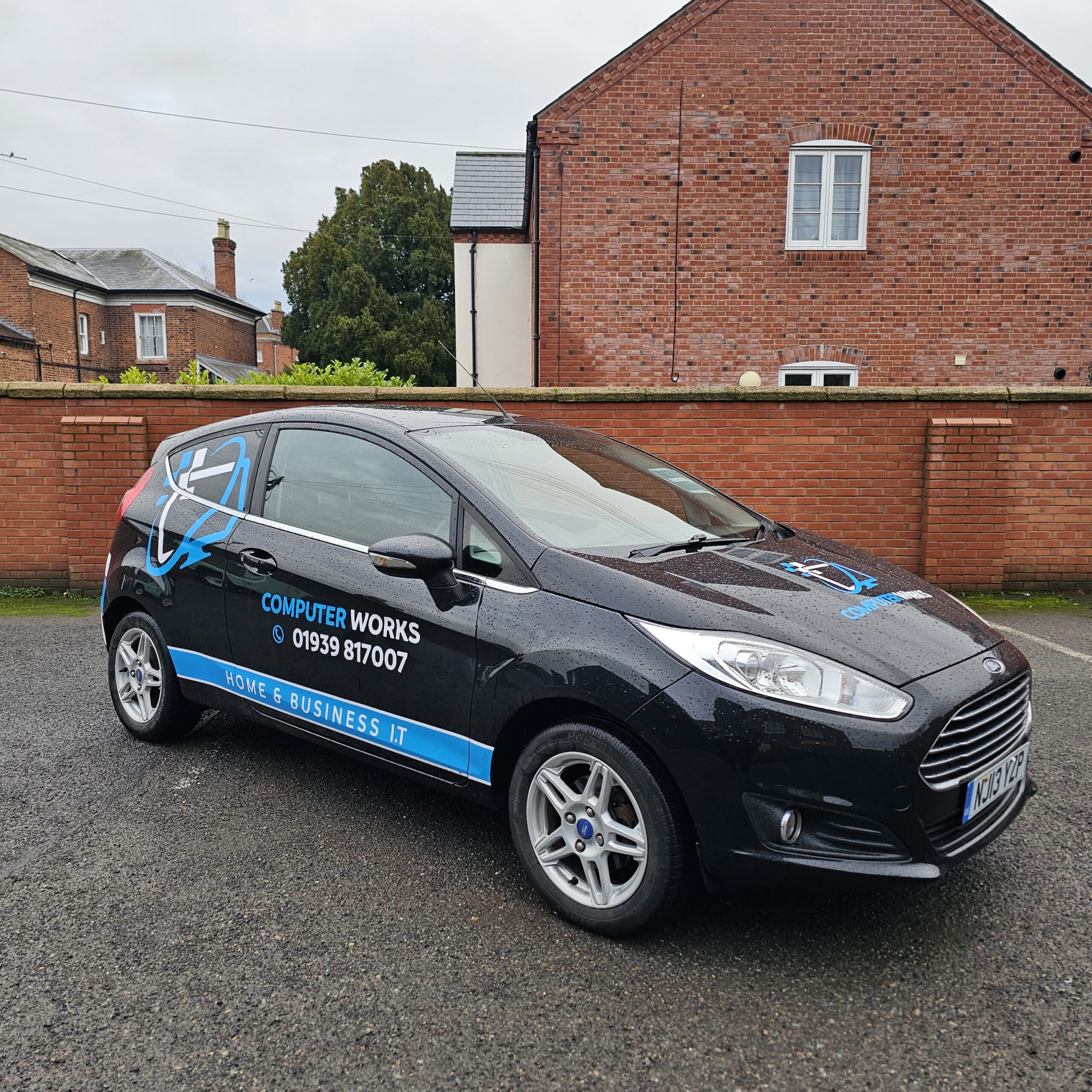 Computerworks branded black Ford Fiesta with blue graphics, advertising home and business IT support services, parked outside a local business in Wem